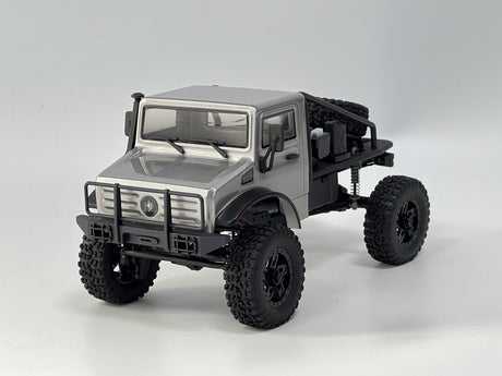 Sleek silver 1/18 scale RC Trail Hunter off-road vehicle with rugged all-terrain tires and impressive suspension for outdoor adventures.