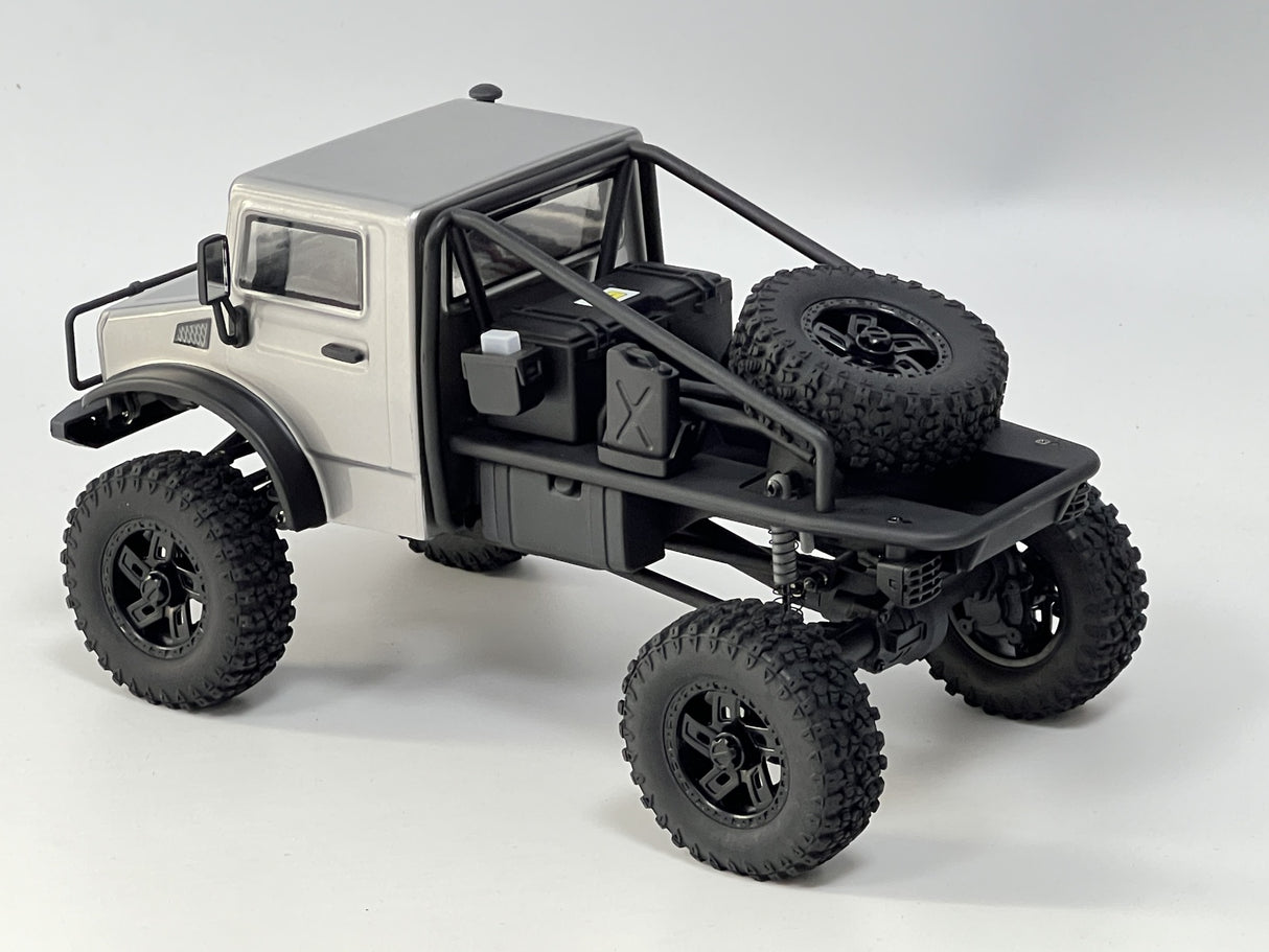 Rugged RC trail truck: Hobby Plus 1/18 CR18P EVO, silver-colored, with off-road tires and detailed chassis, ready for remote-controlled adventures.
