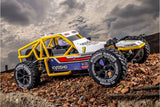 White and blue Kyosho 1/10 Sandmaster 2.0 Electric RTR RC Buggy on rocky terrain against cloudy sky backdrop.