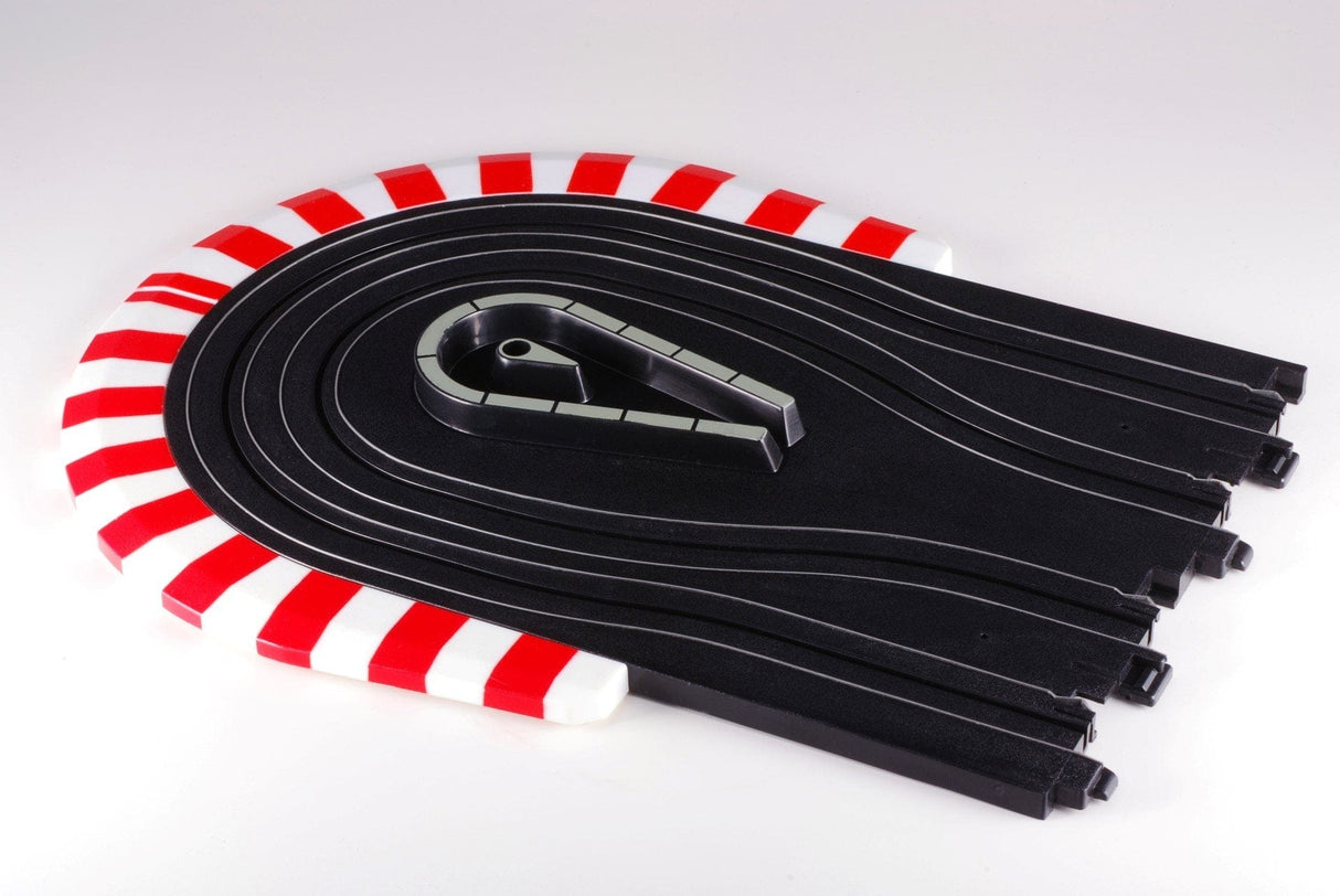 Curved black slot car track with red and white striped borders, featuring a section of the track on display.