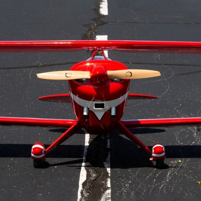 Sleek red and black Hangar 9 Pitts S-2B 60cc ARF RC aircraft with propellers and detailed features.