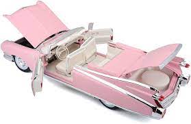 Detailed 1/18 scale Maisto model of a 1959 Cadillac Eldorado Biarritz in a vibrant pink color, showcasing the classic car's sleek design and iconic fins.