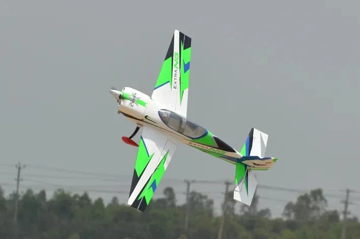 Green and white Phoenix model extra next gen 50cc carbon ARF RC plane in flight against cloudy sky.