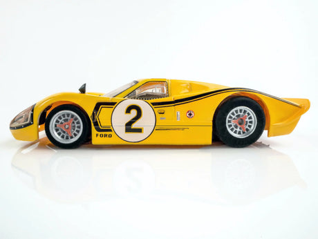 Iconic yellow Ford GT40 MKIV race car, number 2, competing at the 1967 Le Mans race.