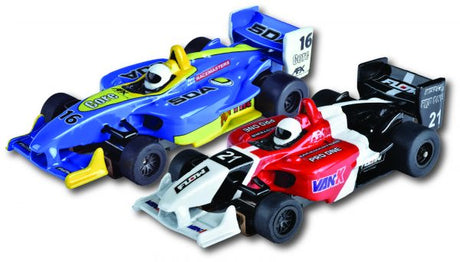 Two colorful F1 style slot cars with detailed designs, showcasing high-speed racing action for collectors and enthusiasts.