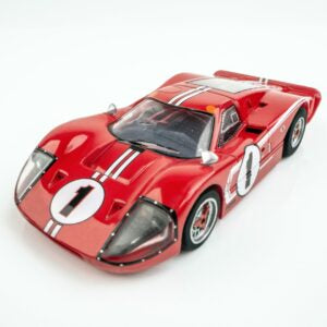 Detailed red Ford GT40 MKIV slot car model with racing number 1, displaying sleek aerodynamic design and classic sports car styling.