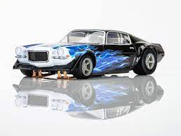 Sleek 1973 Camaro Wildfire slot car in black and blue hues, showcasing its powerful design and dynamic racing styling.