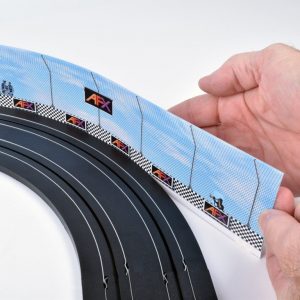 Plastic race barriers in blue, black, and red set against a white background, perfect for slot car racing tracks.