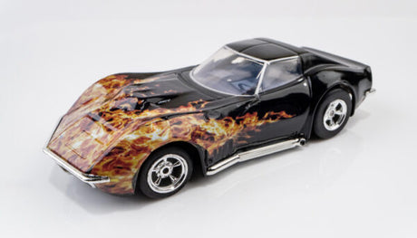 Sleek black 1968 Corvette 427 slot car with fiery orange and red flame graphic design.