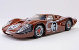 Copper-colored AFX 22053 Ford GT40 MKIV #3 Le Mans 1967 slot car model with detailed design and racing livery.