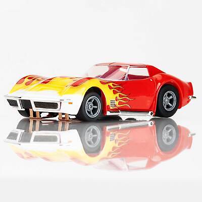 Bright red Corvette slot car with yellow flame decals, ready to race on the track.