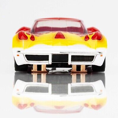 Red and yellow flaming Corvette slot car model by AFX, with sleek design and dynamic racing details.