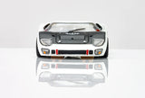 Detailed 1:32 scale model of the classic Ford GT40 race car, featuring a sleek silver and black body, distinctive headlights, and intricate detailing.