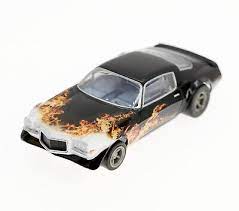 Detailed 1973 Camaro Wildfire slot car in black, yellow, and orange color scheme.