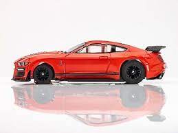 Detailed red 2021 Shelby GT500 slot car with realistic design and racing features.