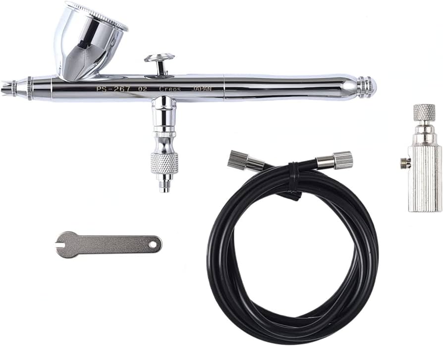 Compact airbrush kit with dual-action trigger for precise control. Chrome-plated metal body and adjustable nozzle for versatile application.