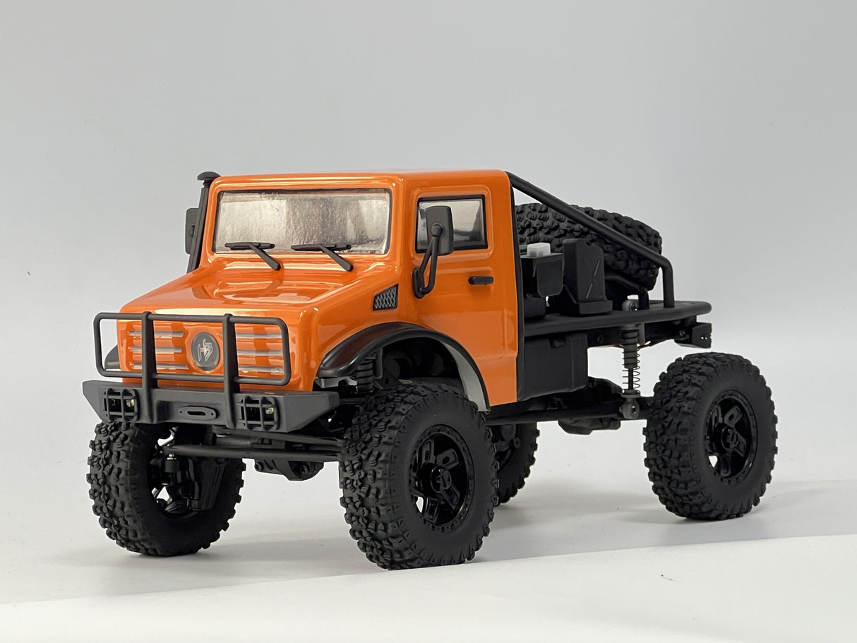 Rugged orange off-road RC truck with large all-terrain tires, detailed design, and heavy-duty features for outdoor adventures.