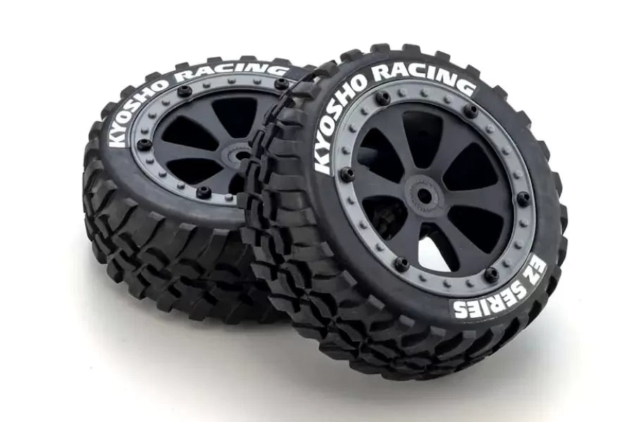 Pair of Kyosho 1/10 high-performance off-road RC buggy tires with aggressive treads and black alloy wheels.