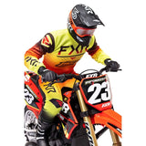 Stylized RC motorcycle with FXR branding and number 23, ridden by a driver wearing a protective helmet and bright yellow and orange racing gear.