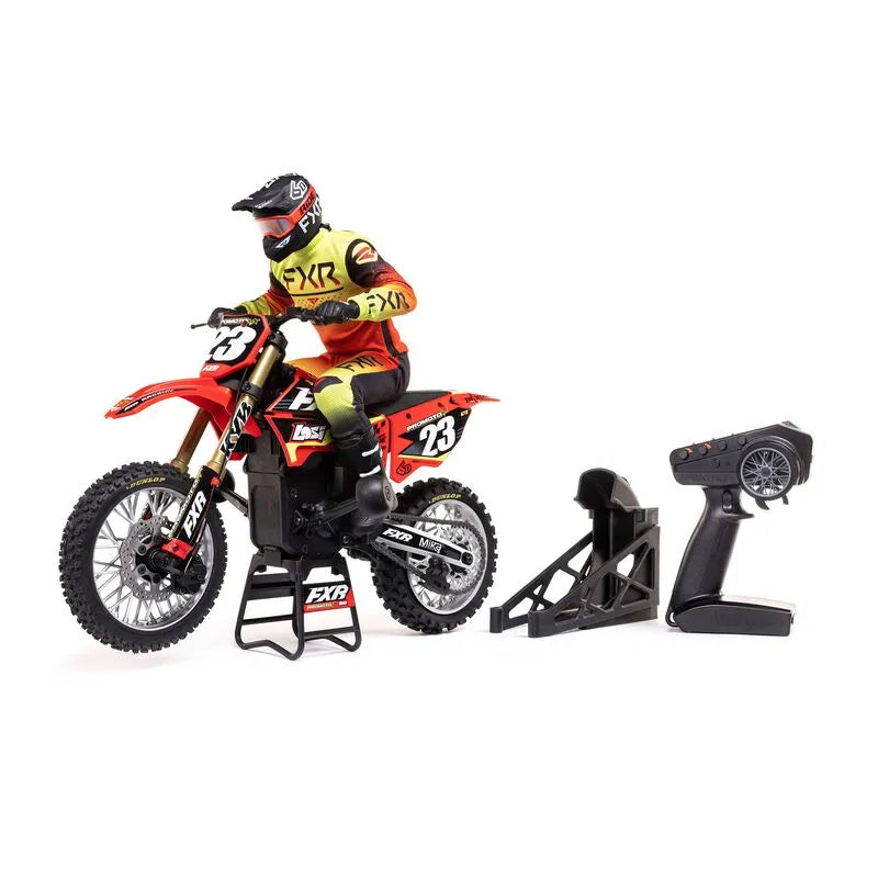 Realistic Losi Promoto-MX 1/4 scale RC motorcycle with rider, remote control, and dirt bike accoutrements.