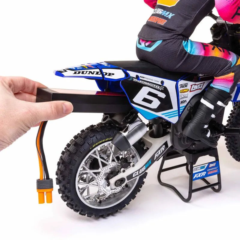 Detailed 1/4 scale Losi Promoto-MX RC motorcycle in colorful ClubMX racing livery, with realistic off-road tires and sleek design features.