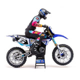Blue and black radio-controlled motocross motorcycle on display stand.