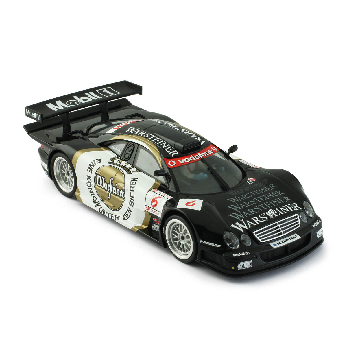 Detailed 1/32 scale model of the Mercedes CLK GTR No.6 Warsteiner GT1 Class slot car, displayed in a black and white color scheme with prominent Warsteiner branding. The model features a sleek, aerodynamic design characteristic of high-performance racing vehicles.