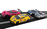 Vibrant Scalextric racing cars on track, featuring diverse sports car designs in pink, yellow, and blue.