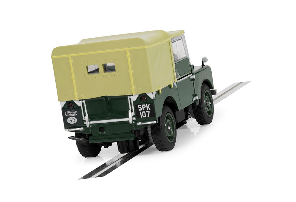 Detailed green and yellow Land Rover Series 1 slot car, showcased on a track surface.