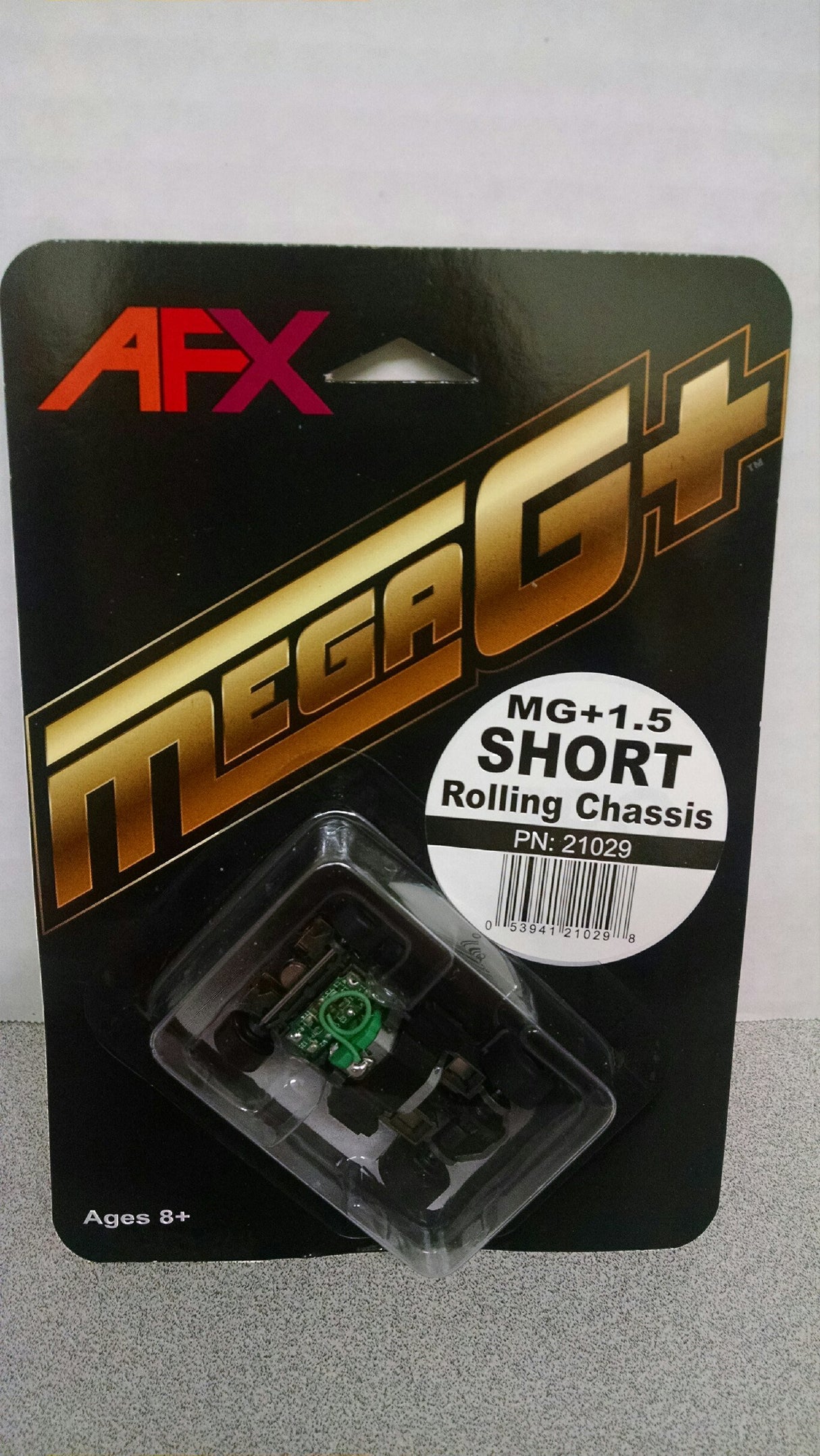 Sleek AFX Mega-G+ short 1.5 in wheelbase roll chassis, designed for high-performance slot car racing.