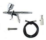 Sleek chrome airbrush with trigger, hose, and accessories for precision painting and detailing.