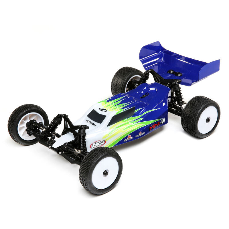 Compact 1/16 Scale 2WD Buggy. Blue and white RC car with green accents, featuring large off-road tires and a sleek, aerodynamic body design for high-speed racing.