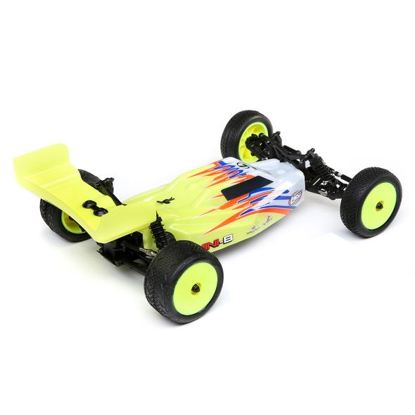 Compact 1/16 scale remote-controlled Losi Mini-B buggy in vibrant yellow and red color scheme, featuring off-road tires and a sleek, aerodynamic body design for high-speed RC racing action.
