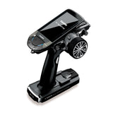 Futaba 10PXR radio gear with two R404SBS receivers and a charger, featuring a sleek black touchscreen controller on a stylish stand.