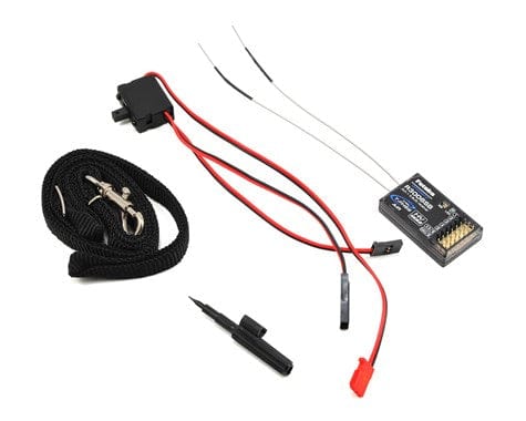 Futaba 6k FHSS Transmitter with R3006SB Receiver, featuring a compact control unit, wireless connectivity, and durable accessory components.