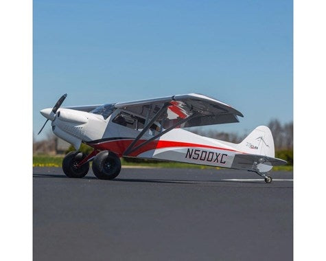 Sleek Hangar 9 Cub Crafters XCub 60cc ARF RC plane with distinctive red and white markings on the runway.