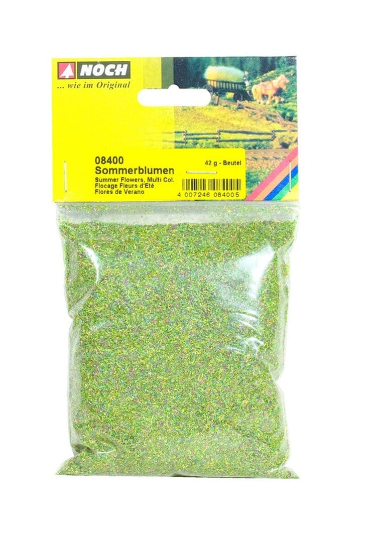 Vibrant summer flowers in various colors decorate this detailed model train scenery piece from Noch.